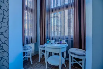 a room with a table and two stools and a window at Istiklal Nil Suites in Istanbul