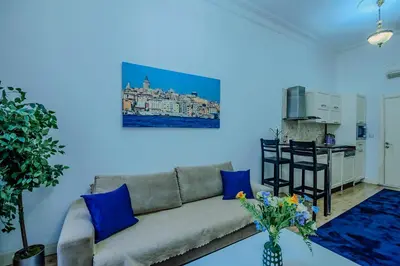 a living room with a couch and a kitchen at Istiklal Nil Suites in Istanbul