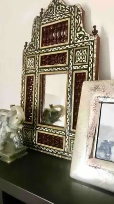 a gold frame sitting on a table next to a picture at A million dollar view of the Bosporus and balcony in Istanbul