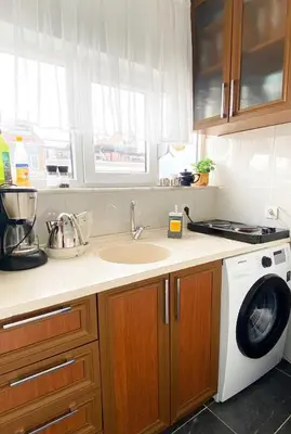 a kitchen with a sink and a washing machine at A million dollar view of the Bosporus and balcony in Istanbul