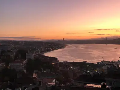 a view of a city with the ocean at sunset at A million dollar view of the Bosporus and balcony in Istanbul