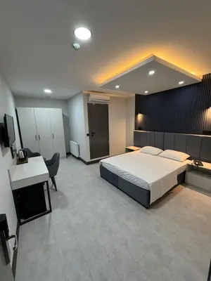 a bedroom with a large bed and a desk and a desk at Trio Palace in Istanbul