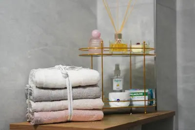 a pile of towels on a shelf in a bathroom at Kadir Bey Apt in Istanbul
