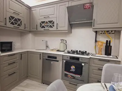 a kitchen with white cabinets and a stove top oven at Kadir Bey Apt in Istanbul