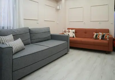 a living room with a gray couch and a orange couch at Kadir Bey Apt in Istanbul