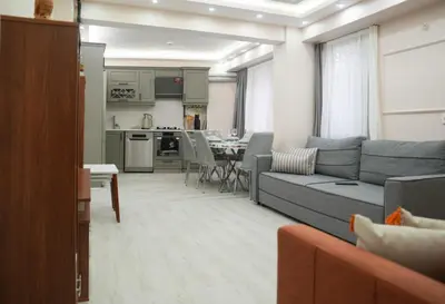 a living room with a couch and a dining room at Kadir Bey Apt in Istanbul