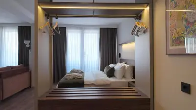 a hotel room with a bed and a mirror at Yıldız Termal Otel in Çekirge İstasyonu