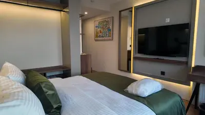 a bedroom with a bed and a flat screen tv at Yıldız Termal Otel in Çekirge İstasyonu