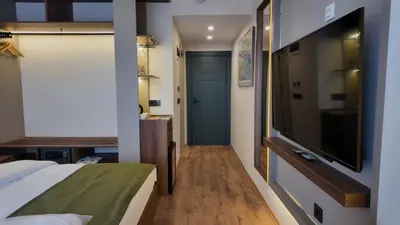 a bedroom with a bed and a flat screen tv at Yıldız Termal Otel in Çekirge İstasyonu