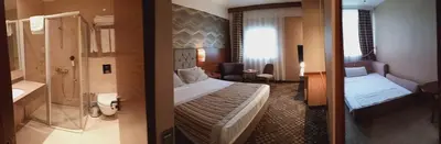 a hotel room with a bed and a bathroom at Adranos Hotel in Bursa