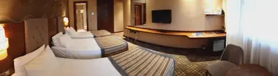 a hotel room with two beds and a television at Adranos Hotel in Bursa