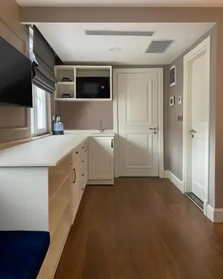 a kitchen with white cabinets and a counter top at Ozkaya Apartments Galata in Istanbul