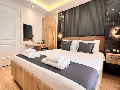 a bedroom with a large bed with towels on it at The Bail Hotel in Istanbul