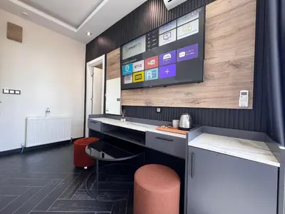 a room with a desk and a tv on the wall at The Bail Hotel in Istanbul