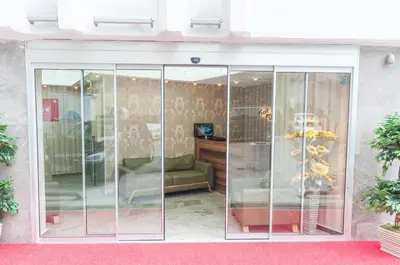 a room with glass doors with a couch in it at Best Fulya Suites in Istanbul