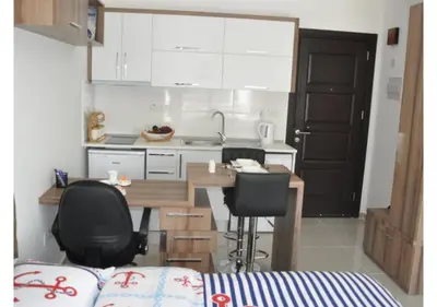 a kitchen with a table and chairs and a counter top at White Palace Apart in Istanbul