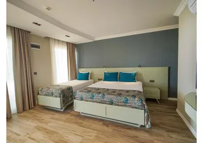 a bedroom with two beds with blue pillows at White Palace Apart in Istanbul