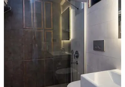 a bathroom with a shower and a toilet and a sink at White Palace Apart in Istanbul