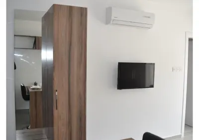 a flat screen tv hanging on a white wall at White Palace Apart in Istanbul
