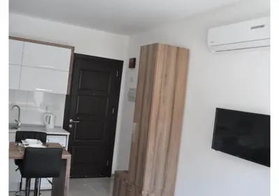 a room with a black door and a desk and a television at White Palace Apart in Istanbul