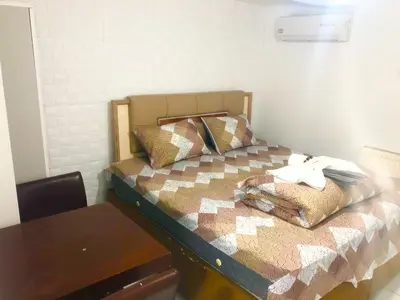 a small bedroom with a bed and a table at Taksim White Mansion Hotel in Istanbul