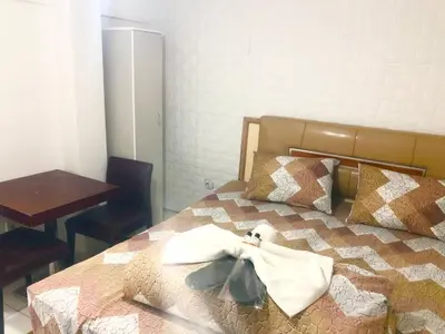 a bedroom with a bed with a robe on it at Taksim White Mansion Hotel in Istanbul