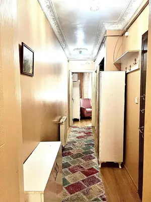 a hallway with a long room with a table at Taksim White Mansion Hotel in Istanbul