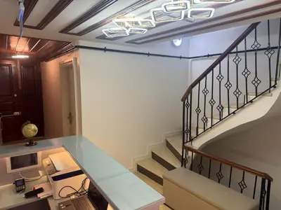 a room with a staircase with a desk and a stair case at Neo Konak in Istanbul