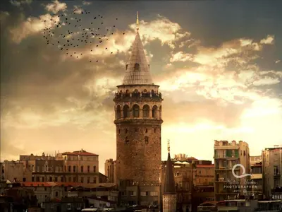 a tall tower with a spire in a city at Grafen Hotel in Istanbul