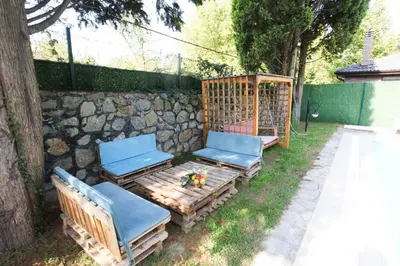 a group of chairs sitting next to a stone wall at Sakarya Sapanca da Özel Havuzlu , Ailelere Özel Villalar in Sapanca