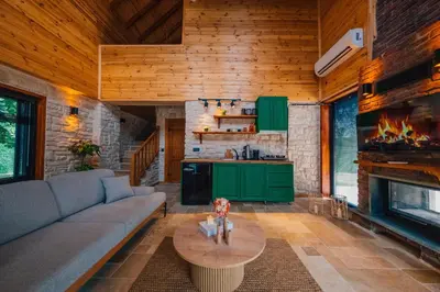 a living room with a couch and a fireplace at Kartepe Maşukiye de 2 oda1 salon Özel Havuzlu - Şömineli -Muhafazakar 5 Kişilik Bungalov in Korfez