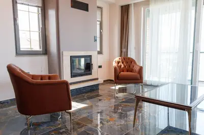 a living room with two chairs and a fireplace at Comfort 4 bedroom villa yalova see view in Yalova
