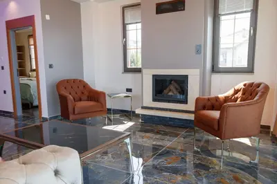a living room with two chairs and a fireplace at Comfort 4 bedroom villa yalova see view in Yalova