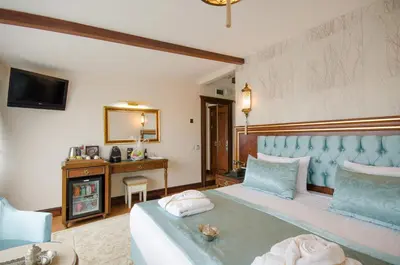 a bedroom with a large bed and a television at Arden City Hotel-Special Category in Istanbul