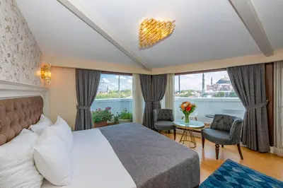 a hotel room with a bed and a large window at Arden City Hotel-Special Category in Istanbul