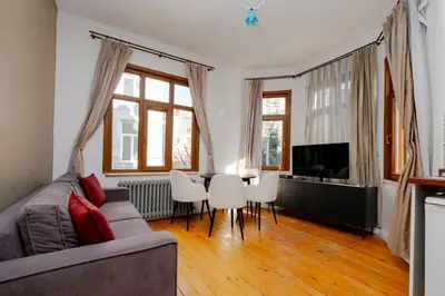 a living room with a couch and a table and chairs at Exclusive House with 2 Apartments including 4 Bedrooms and 4 Bathrooms in Total in Istanbul
