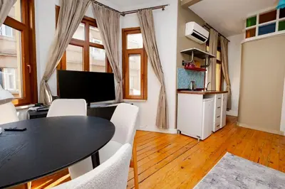 a dining room with a black table and white chairs at Exclusive House with 2 Apartments including 4 Bedrooms and 4 Bathrooms in Total in Istanbul