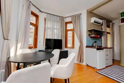 a living room with a table and white chairs at Exclusive House with 2 Apartments including 4 Bedrooms and 4 Bathrooms in Total in Istanbul