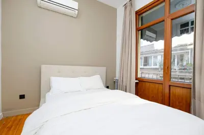 a bedroom with a white bed and a window at Exclusive House with 2 Apartments including 4 Bedrooms and 4 Bathrooms in Total in Istanbul