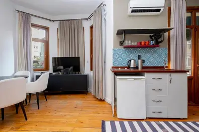a kitchen with a counter and a table with chairs at Exclusive House with 2 Apartments including 4 Bedrooms and 4 Bathrooms in Total in Istanbul