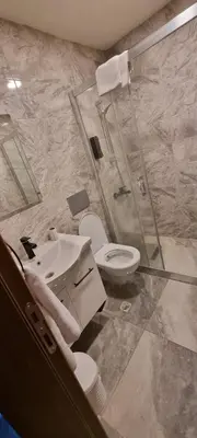 a bathroom with a shower and a toilet and a sink at The my hotel darica in Darıca