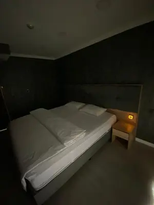 a bedroom with a white bed and a night stand at The my hotel darica in Darıca