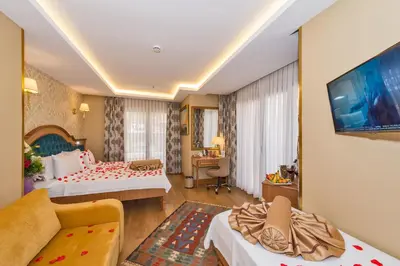 a hotel room with two beds and a flat screen tv at Aprilis Gold Hotel - Special Category in Istanbul