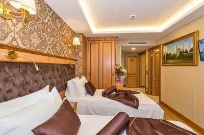 a hotel room with two beds and a couch at Aprilis Gold Hotel - Special Category in Istanbul