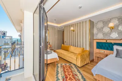 a hotel room with a bed and a couch at Aprilis Gold Hotel - Special Category in Istanbul