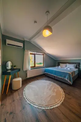 a bedroom with a bed and a window and a rug at Sepetçi Lakehouse Heated Pool in Kartepe