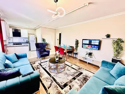 a living room with blue couches and a table at Apartment in Sisli Mado14 in Istanbul