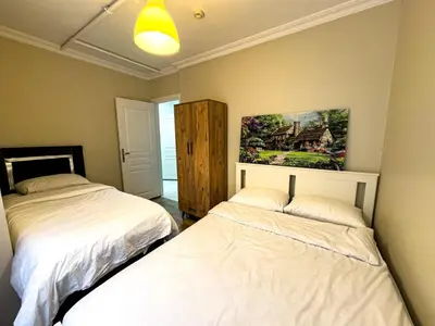 a bedroom with two beds and a painting on the wall at Apartment in Sisli Mado14 in Istanbul
