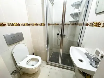 a bathroom with a toilet and a shower and a sink at Apartment in Sisli Mado14 in Istanbul