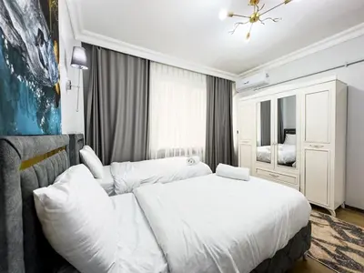 a bedroom with a white bed and a mirror at Dream Apartment in Sheshli 5 4 1 in Istanbul